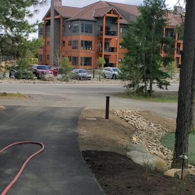 Apartment building with parking lot and landscaping.