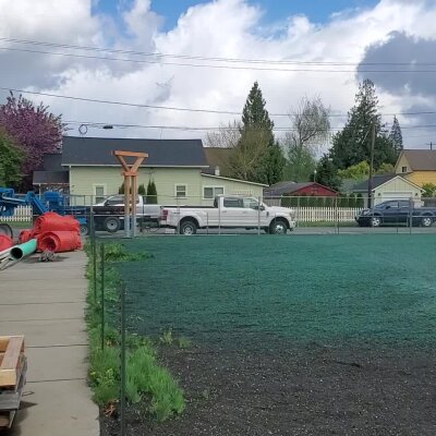 Hydroseeded lawn with equipment and truck in Washington State.