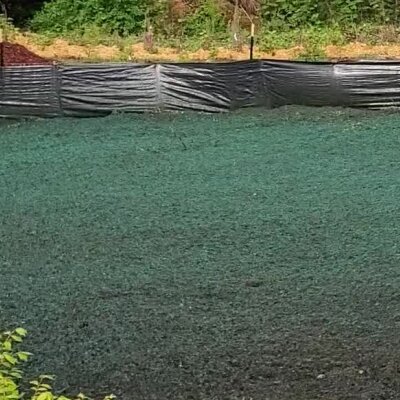 Freshly hydroseeded lawn with protective silt fence in Washington State.