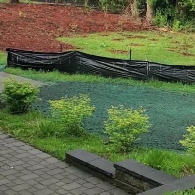 Freshly hydroseeded lawn with protective fencing in Washington State.